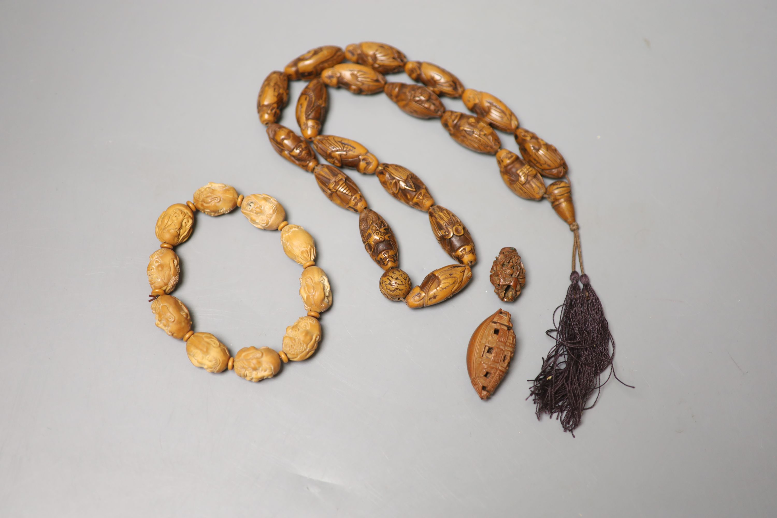 A coquilla nut necklace, bracelet and two small ornamental carvings